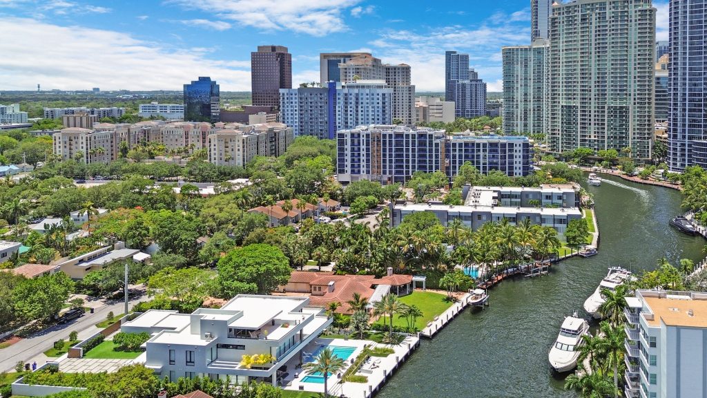 Aerial view of Miami's downtown skyline with high-rise buildings and waterfront marina.