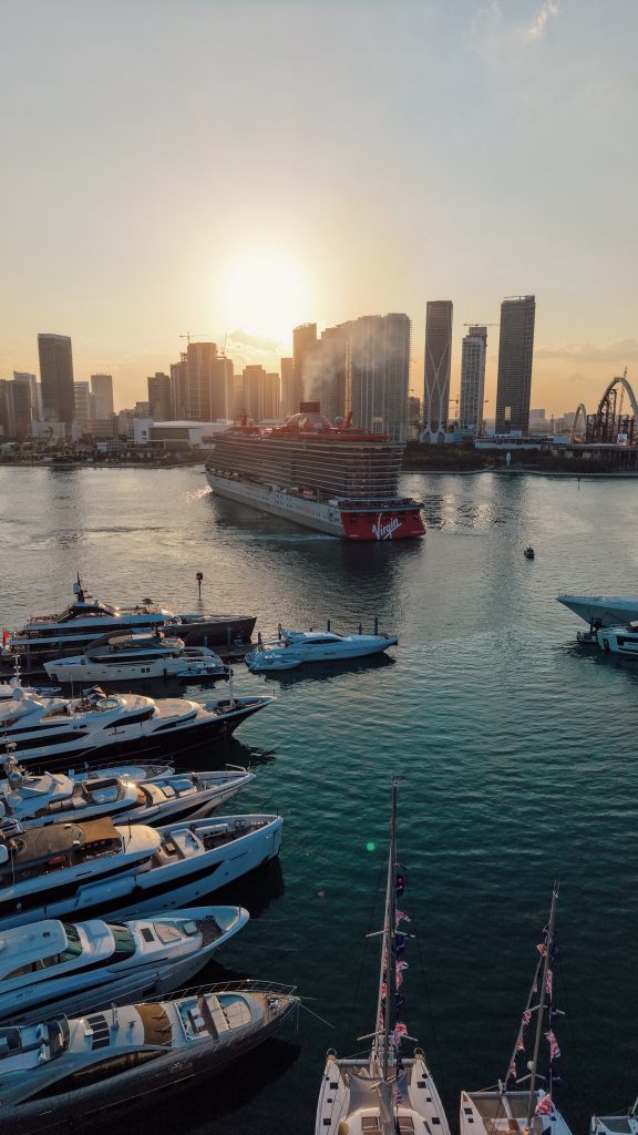 Luxury yachts docked at Miami harbor during sunset.