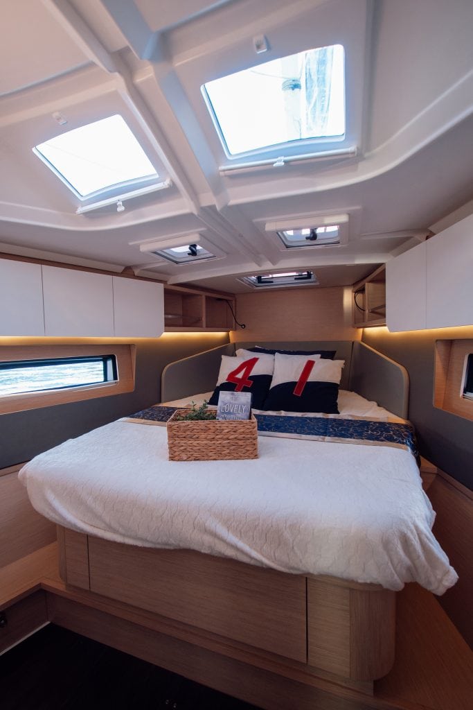 Elegant yacht bedroom with skylights and modern decor.