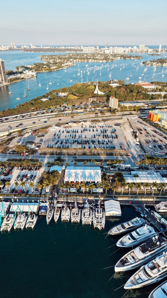 Aerial view of Miami yacht marina and surrounding waterway with boats and city skyline.