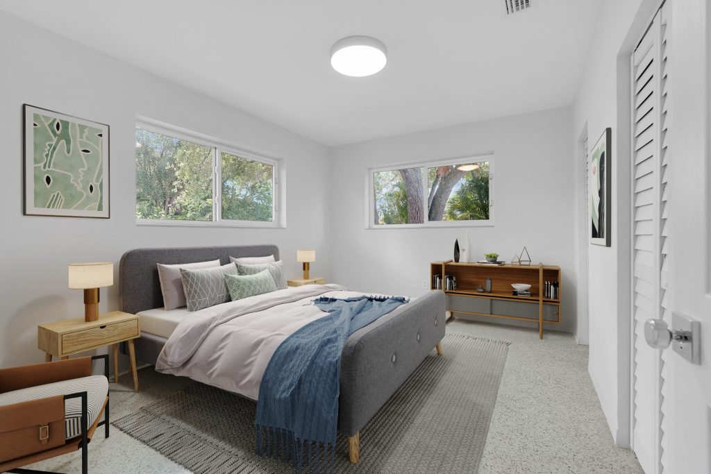 Bedroom with large windows, natural light, and contemporary furniture.