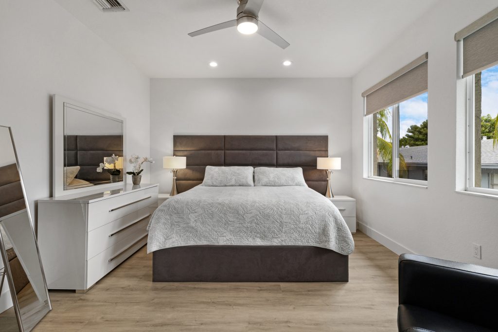 Bright modern bedroom with large windows and minimalist decor.