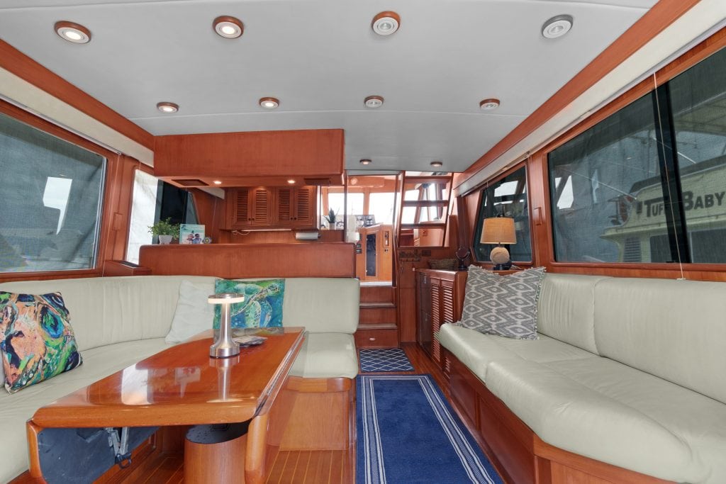 Luxury yacht interior with wooden accents and comfortable seating.