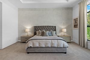 Elegant bedroom featuring a plush bed, soft lighting, and scenic window view.
