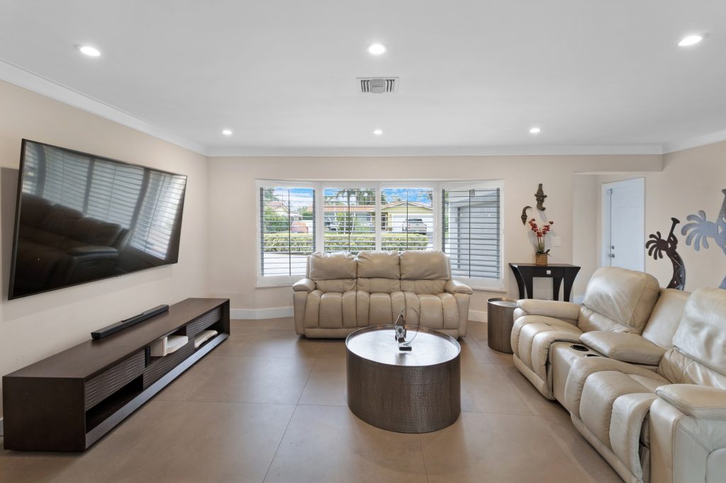 Spacious living room with large windows and modern furniture.