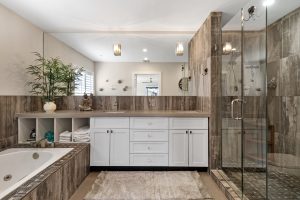 Spacious bathroom with walk-in shower, bathtub, and elegant decor.