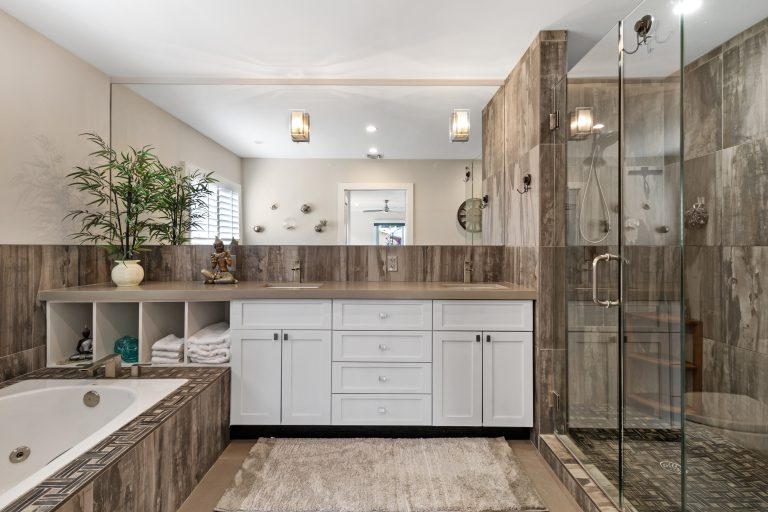 Spacious bathroom with walk-in shower, bathtub, and elegant decor.
