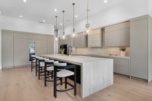 Modern minimalist kitchen with sleek cabinetry, island, and pendant lighting for contemporary home s.
