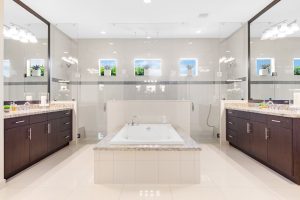 Luxury spa bathroom featuring a central bathtub, double vanities, and large mirrors for a relaxing r.