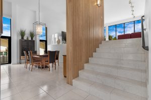 Bright modern interior with staircase and dining space at AccuTour.com.