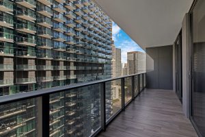Balcony overlooking high-rise buildings in a cityscape.