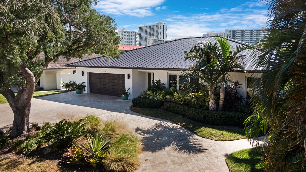 AccuTour.com - Modern house with tropical landscaping and palm trees.