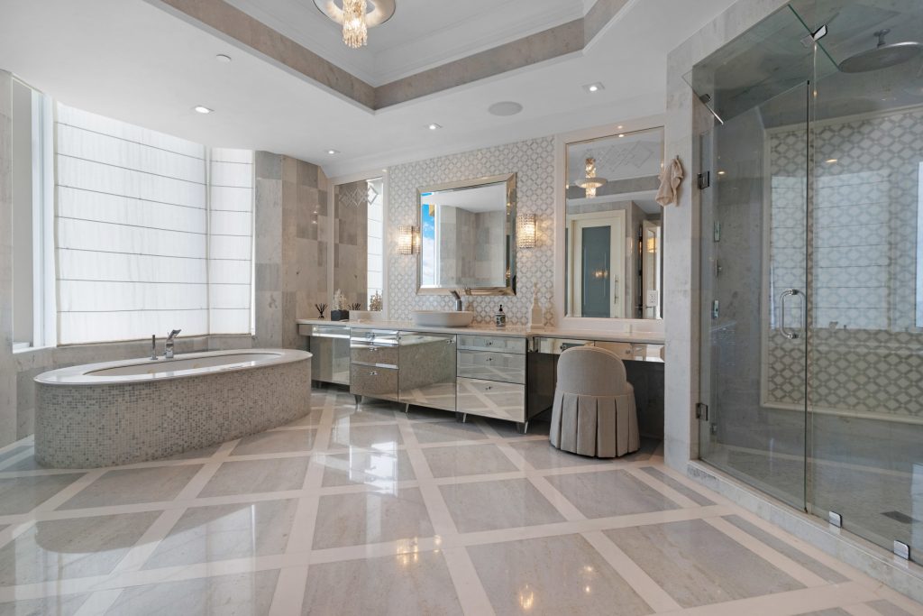 Elegant bathroom with Jacuzzi, glass shower, and modern decor.
