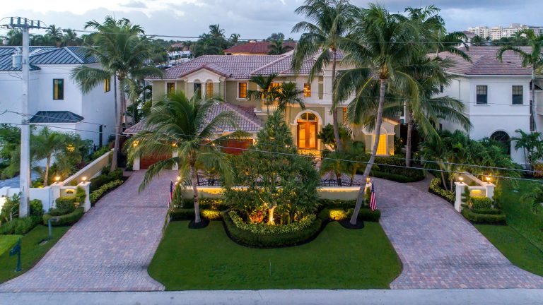 Opulent Miami estate featuring tropical gardens, palm trees, and elegant architecture.