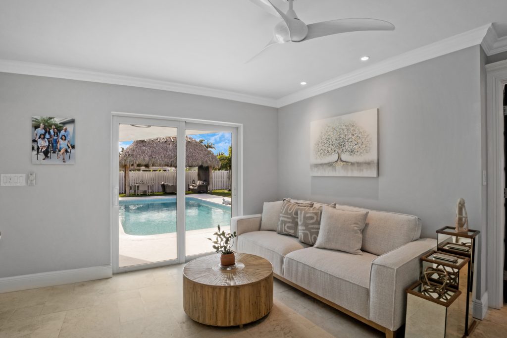 Bright living room with sliding glass doors to pool area and contemporary decor.