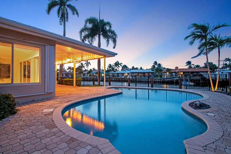 Poolside relaxation with tropical palm trees and sunset views at a luxury resort.