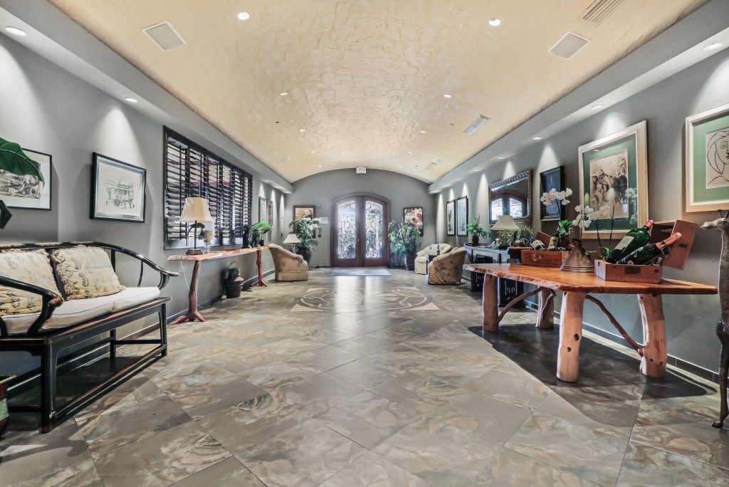 Spacious hotel lobby featuring classic furniture, artwork, and elegant decor.