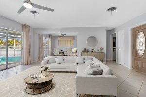 Spacious living room with large windows, sliding glass door, and contemporary decor.
