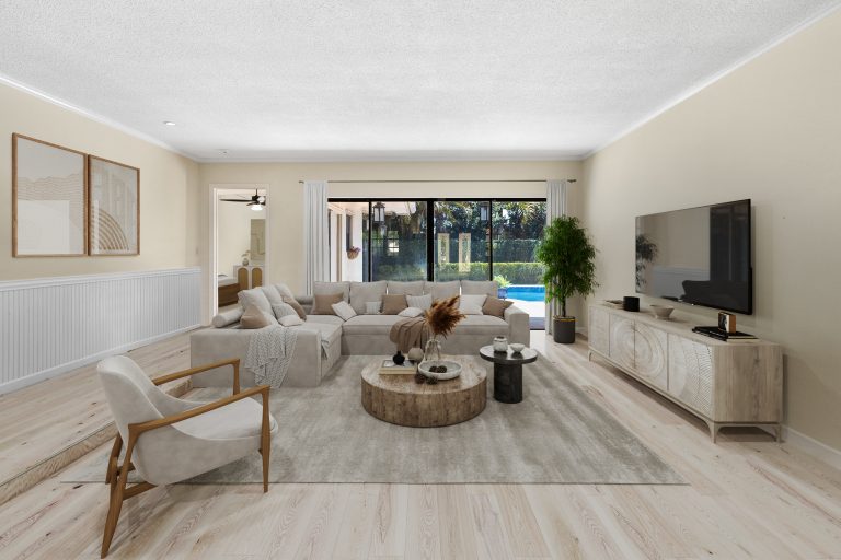 Spacious living room featuring a large window, comfortable sectional sofa, and stylish decor for a w.