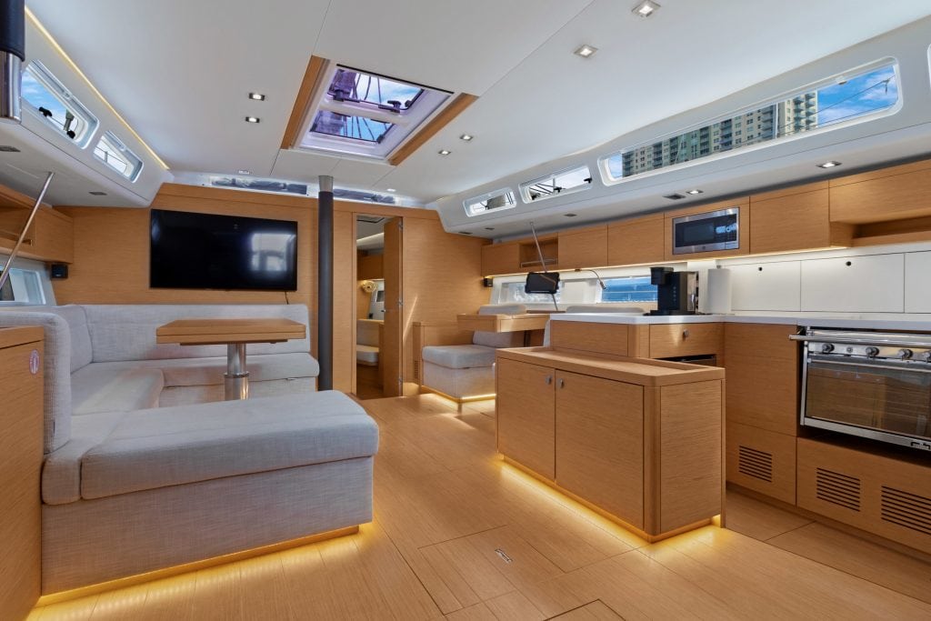 Luxury yacht interior with modern kitchen, seating area, and skylights for a comfortable voyage.