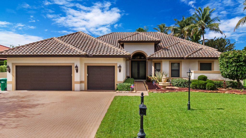 Beautiful single-story house with a lush green lawn and a clear blue sky.