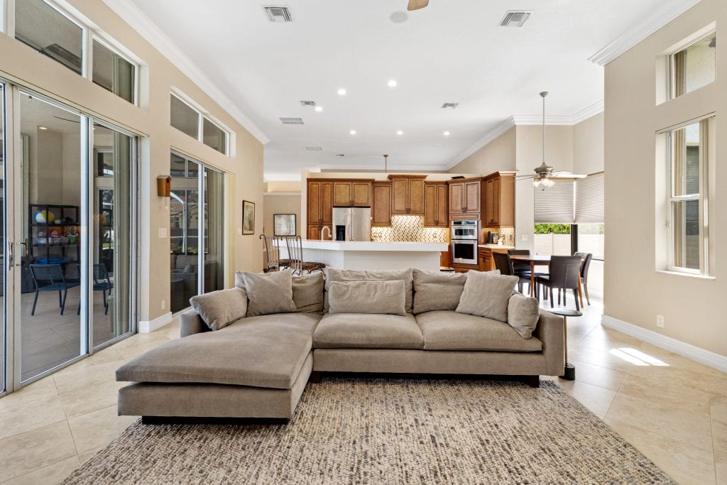Spacious living room with large windows and modern decor.