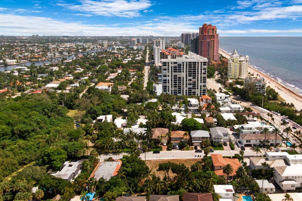 Aerial view of a coastal city with high-rise buildings and beach.