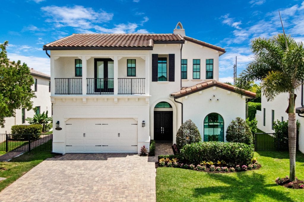 Beautiful modern house with a well-maintained garden and driveway.