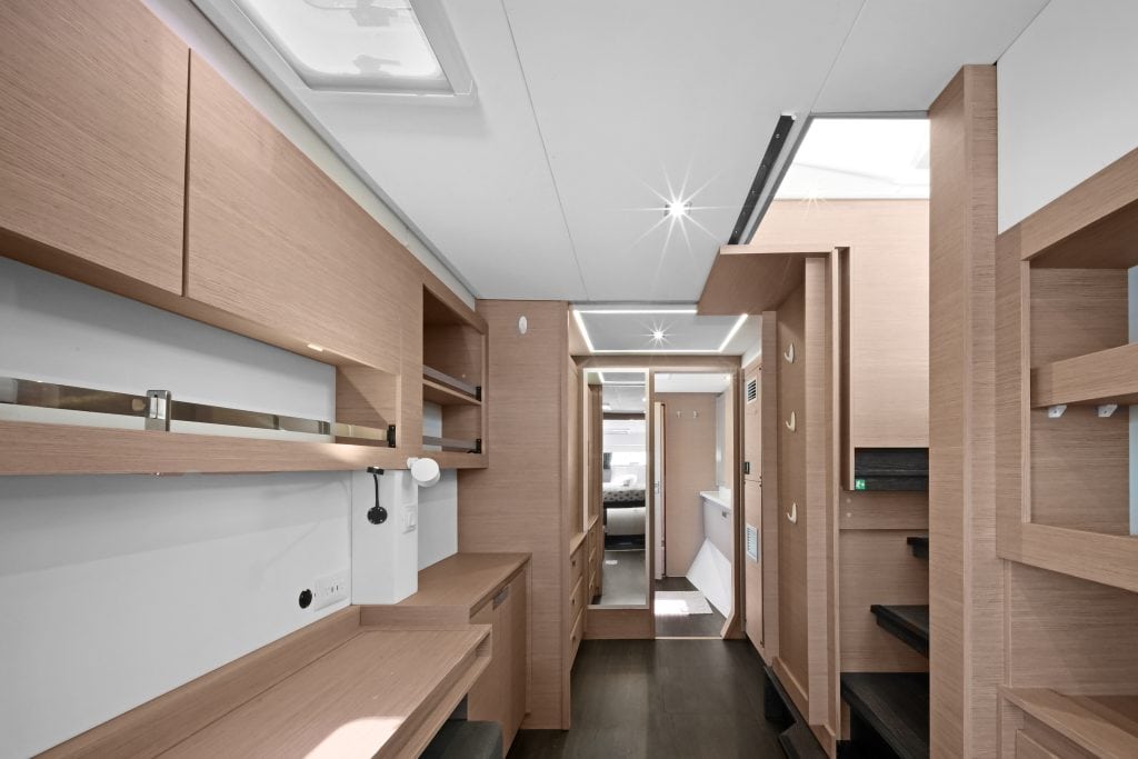 Modern yacht interior with wooden accents and sleek furnishings.