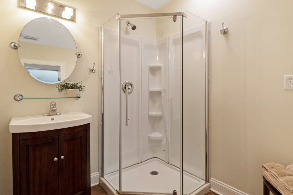 Clean, modern bathroom with glass shower and vanity.