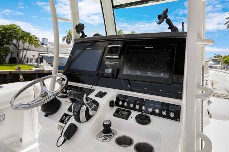 Close-up of yacht control console with navigation and communication equipment.