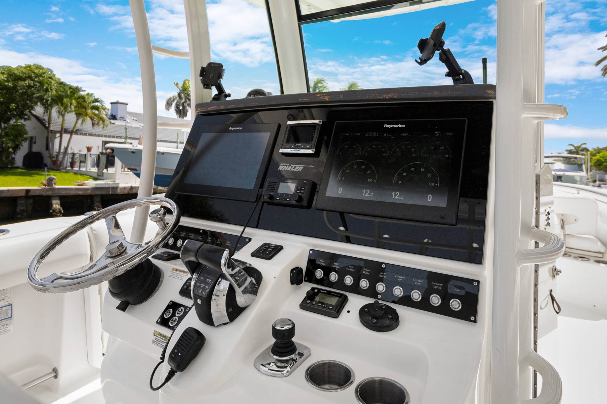 Close-up of yacht control console with navigation and communication equipment.