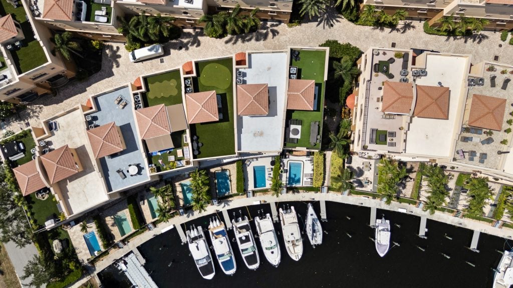 Aerial view of waterfront homes and boats in Pompano Beach, FL.