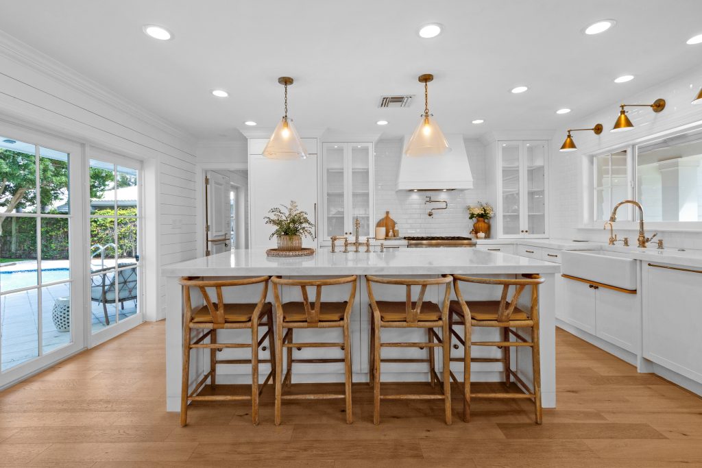 Bright modern kitchen with white cabinets and island, perfect for home cooking and entertaining.