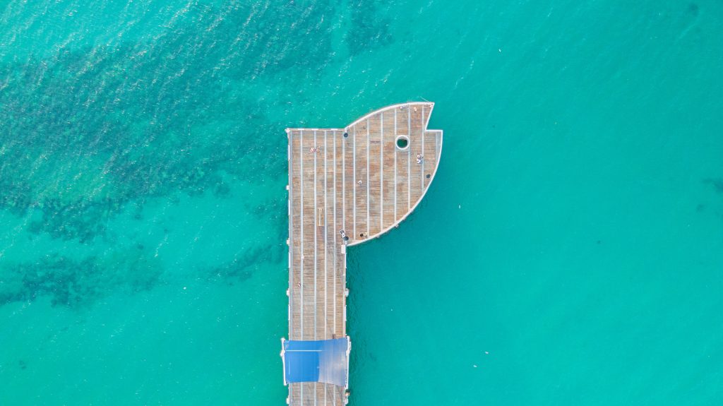 Aerial view of a wooden dock extending into the water in Pompano Beach.