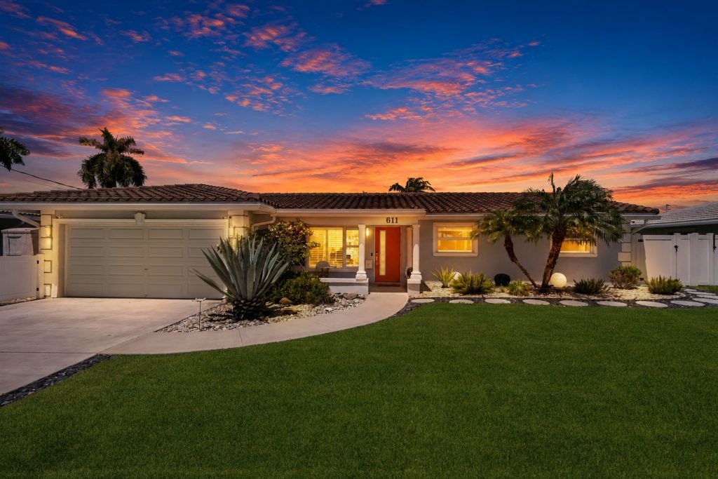 Stunning sunset view of a contemporary house with vibrant sky colors.