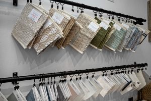 Display of various carpet samples in different colors and patterns at AccuTour.