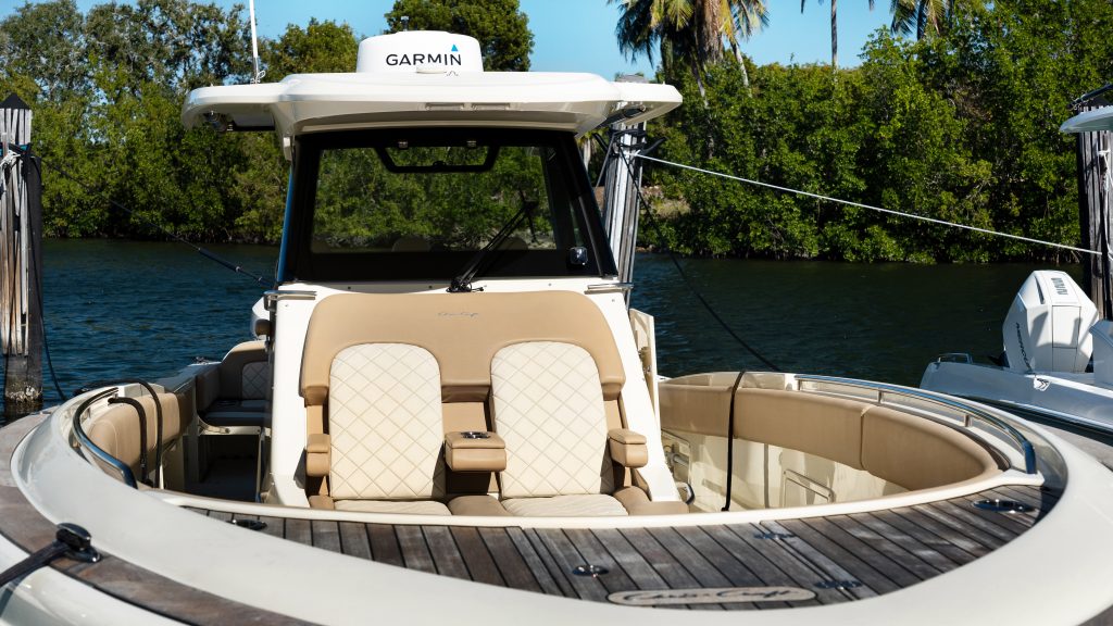 Luxury yacht with beige seating and Garmin navigation system on water.
