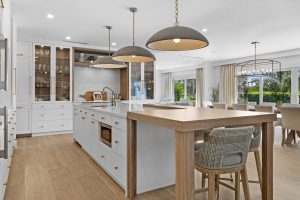 Spacious modern kitchen with island, pendant lighting, and large windows.
